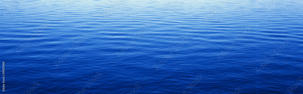 These are water reflections in Lake Tahoe. The water is a deep blue and the small ripples in the water form a pattern. - obrazy, fototapety, plakaty 