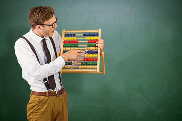 Canvas Print - Composite image of geeky businessman using an abacus