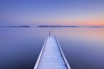  Jetty on a still lake in winter in The Netherlands