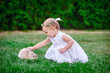 © timonko - Cute little girl with a bunny rabbit has a easter at green grass
