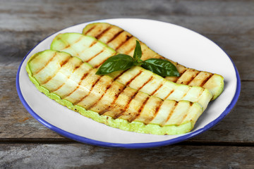 Wall Mural - Grilled vegetable mallow in white plate on wooden table, closeup