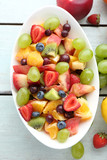 Fototapeta  - Fresh fruit salad on wooden table