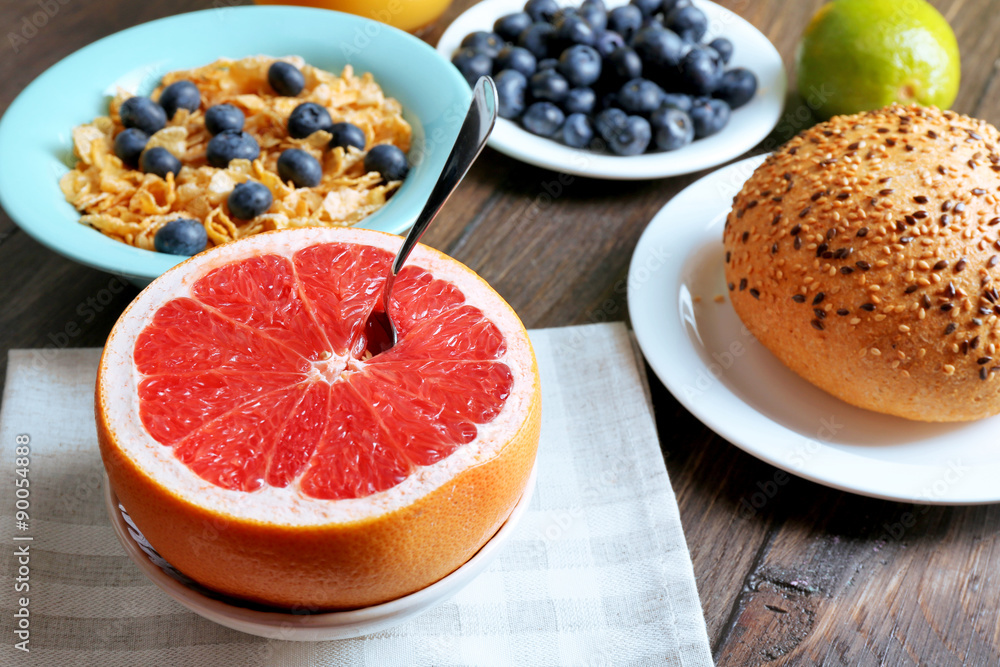 Tasty cornflakes with fruits and berries on table close up