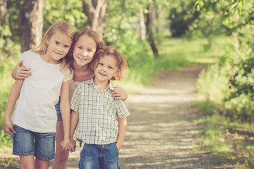 Canvas Print - Portrait of happy children which standing in the park at the day