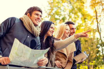 Poster - group of friends with map outdoors