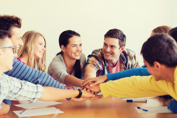 Wall Mural - group of smiling students with hand on top