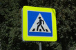 © ykarachev - Дорожный знак пешеходный переход на фоне зеленой листвы.Road sign pedestrian crossing on the background of green foliage.