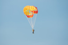 Parachutist In Bright Yellow-orange Parachute Parachute