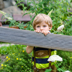 Portrait of beautiful little kid boy in bavarian clothes, outdoo