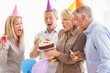 © WavebreakmediaMicro - Casual business people blowing birthday candles