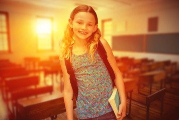 Sticker - Composite image of cute little girl holding book in library