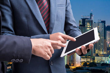 Wall Mural - businessmen using tablet at meeting with blur city night background