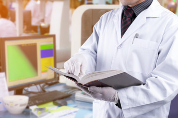 Wall Mural - scientist reading textbook with laboratory background