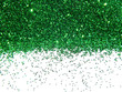 Green glitter sparkle on white background
