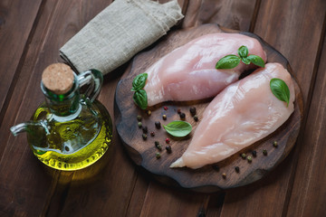 Wall Mural - Raw chicken breast fillet with pepper, green basil and olive oil