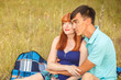 © toomler - beautiful young couple sitting in the field; outdoors
