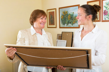 Smiling women purchasing the artwork