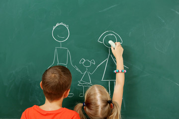 Wall Mural - Children drawing on blackboard at school