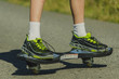 © kulkann - Legs in sneakers on a skateboard