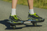Legs in sneakers on a skateboard