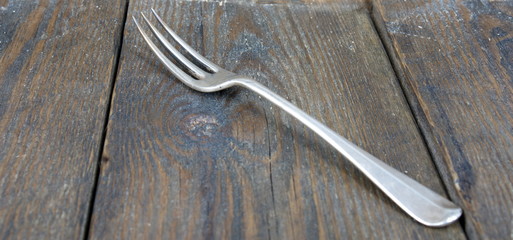 Silver fork on wooden distressed background