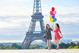 Fototapeta Paryż - Twins with colorful balloons in Paris