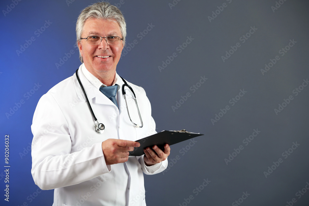 Doctor with clipboard on blue background