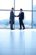 © lenets_tan - Full length image of two successful business men shaking hands