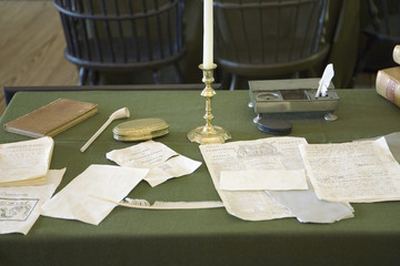 Restored Assembly Room displaying 18th century papers in Independence Hall, Philadelphia, Pennsylvania, one of the meeting places of the Second Continental Congress, where the Declaration of Independence and the Constitution were also debated, adopted, and signed. Future Presidents Washington, John Adams, Jefferson, Madison, and Monroe helped found the Nation in this room.