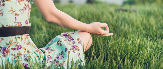 Pretty woman meditate in the park