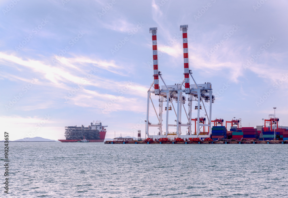 Container Cargo freight ship with working crane bridge in shipyard at ...