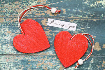 Wall Mural - thinking of you card with two red wooden hearts