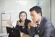 © ndoeljindoel - Young business men and women working on her laptop an office