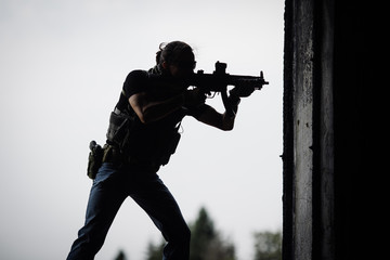 Wall Mural - Silhouette of terrorist with assault rifle