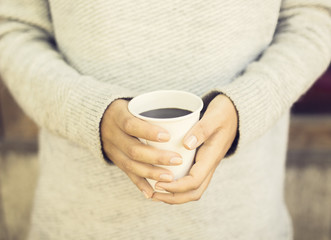 Wall Mural - Girl's hands holding a cup of coffee