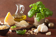 ingredients for pesto sauce over wooden rustic background