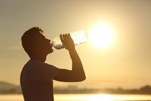 Fitness Man Silhouette Drinking Water From A Bottle