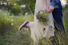 Young Healthy Couple Fashionable Girl In A Wedding Dress Guy In A Plaid Shirt Standing With A Bouquet Of Bright Flowers In Hands, Lifestyle, Love, Wedding