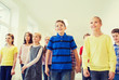 © Syda Productions - group of smiling school kids walking in corridor