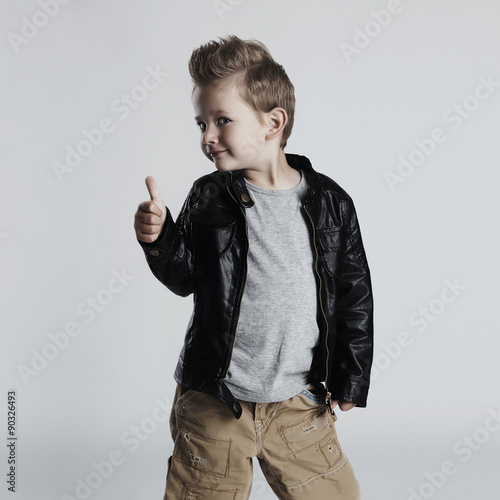Naklejka na meble Fashionable child in leather coat.little boy.funny smiling kid