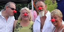 A Group Of People Wearing Clown Red Noses