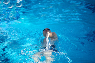 Wall Mural - swimmer excercise on indoor swimming poo