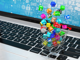 shopping cart with application software icons on laptop