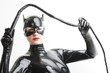 © Richard Semik - portrait of standing woman wearing latex clothes with a whip