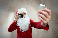 Hipster Santa Makes Selfy With Retro Camera And Smartphone