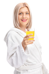 Poster - Young girl in a bathrobe holding an orange juice