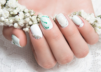 Wedding manicure for the bride in gentle tones with flowers