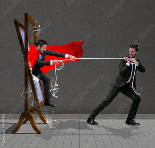 Fotografering Man pulls out super hero from the mirror