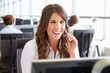 © Monkey Business - Young woman working in a call centre, holding headset