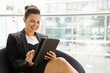 © Monkey Business - Businesswoman using tablet computer in modern interior